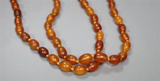 A double strand oval amber bead necklace, 66cm, gross 58 grams.